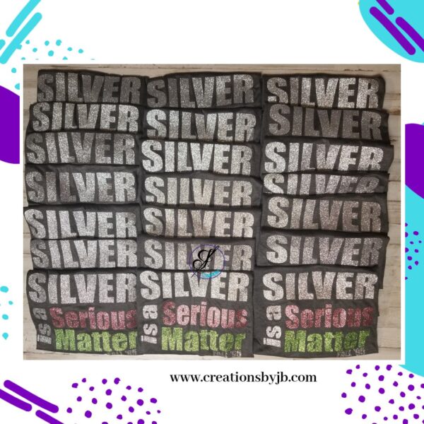 The image shows multiple black t-shirts with text "SILVER is a Serious Matter" printed in silver, green, red, and pink colors. The website "creationsbyjb.com" is displayed at the bottom.