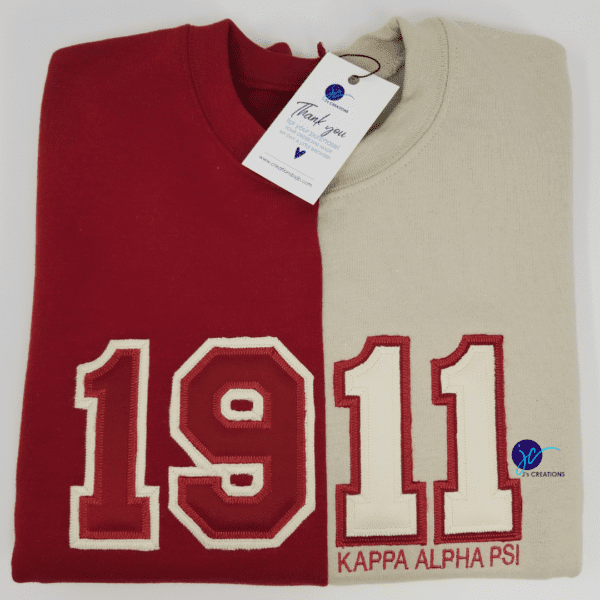 Two Embroidered 1911 Kappa Alpha Psi Inspired Half and Half Crew Neck Unisex Sweatshirts, one red with white "19" and one cream with red "11" and "Kappa Alpha Psi" text, under a "Thank You" tag from a company named Big Creations.