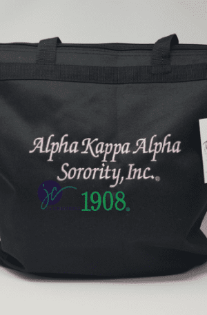Alpha Kappa Alpha Embroidered Tote Bag with “Alpha Kappa Alpha Sorority, Inc. 1908” embroidered in pink and green. A thank you tag is attached to the handle.
