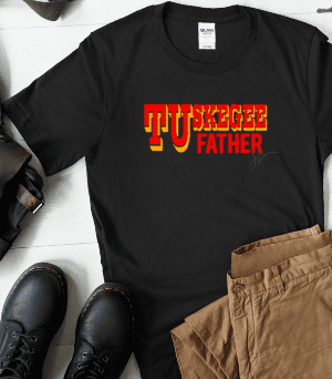 Black TUskegee Family Member Unisex Shirt (Father, Mother, Sister, etc.) with the text "Tuskegee Father" in red and yellow print, laid out on a floor with brown pants, black boots, a bag, a notebook, and a smartphone.