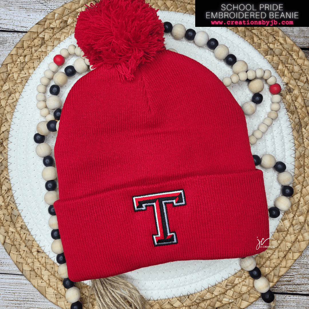 A red beanie with the letter t on it.