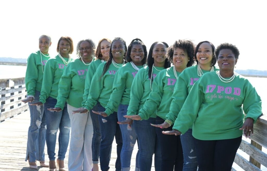 A group of women wearing a customized green sweater