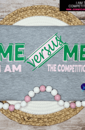 A gray t-shirt with the words " me versus me " on it.