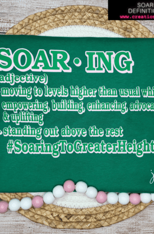 A green napkin with the word " soaring " written on it.