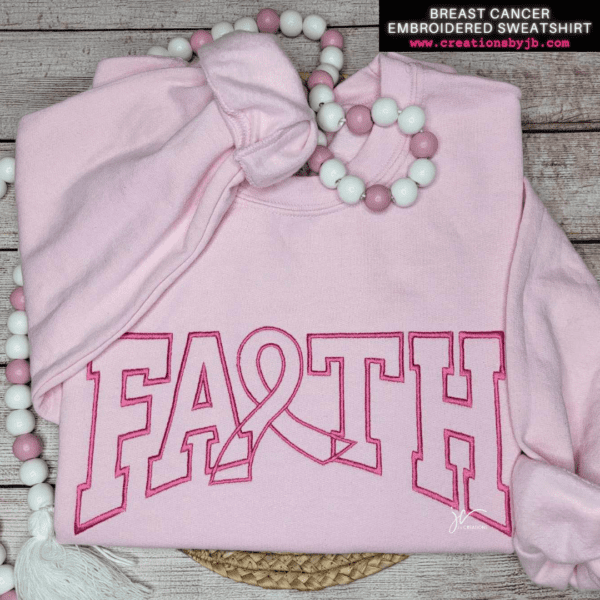 A pink sweatshirt with the word faith on it.