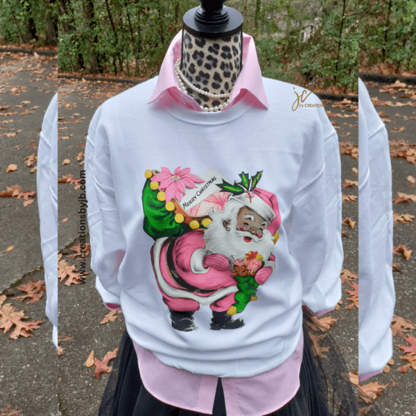 A mannequin wearing a pink shirt and white sweater.