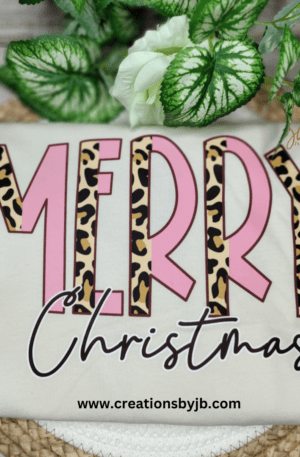 A merry christmas shirt with leopard print and pink lettering.