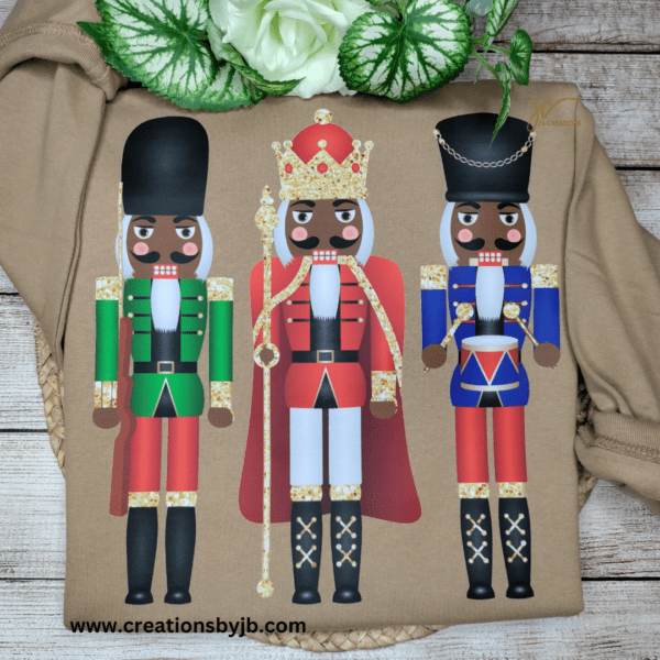 Three nutcrackers are painted on a brown shirt.