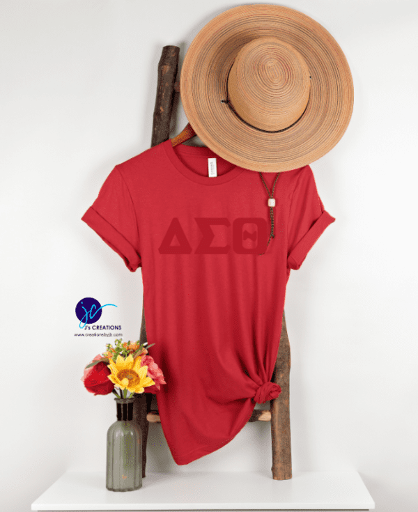 A red shirt with the letters delta sigma theta on it.